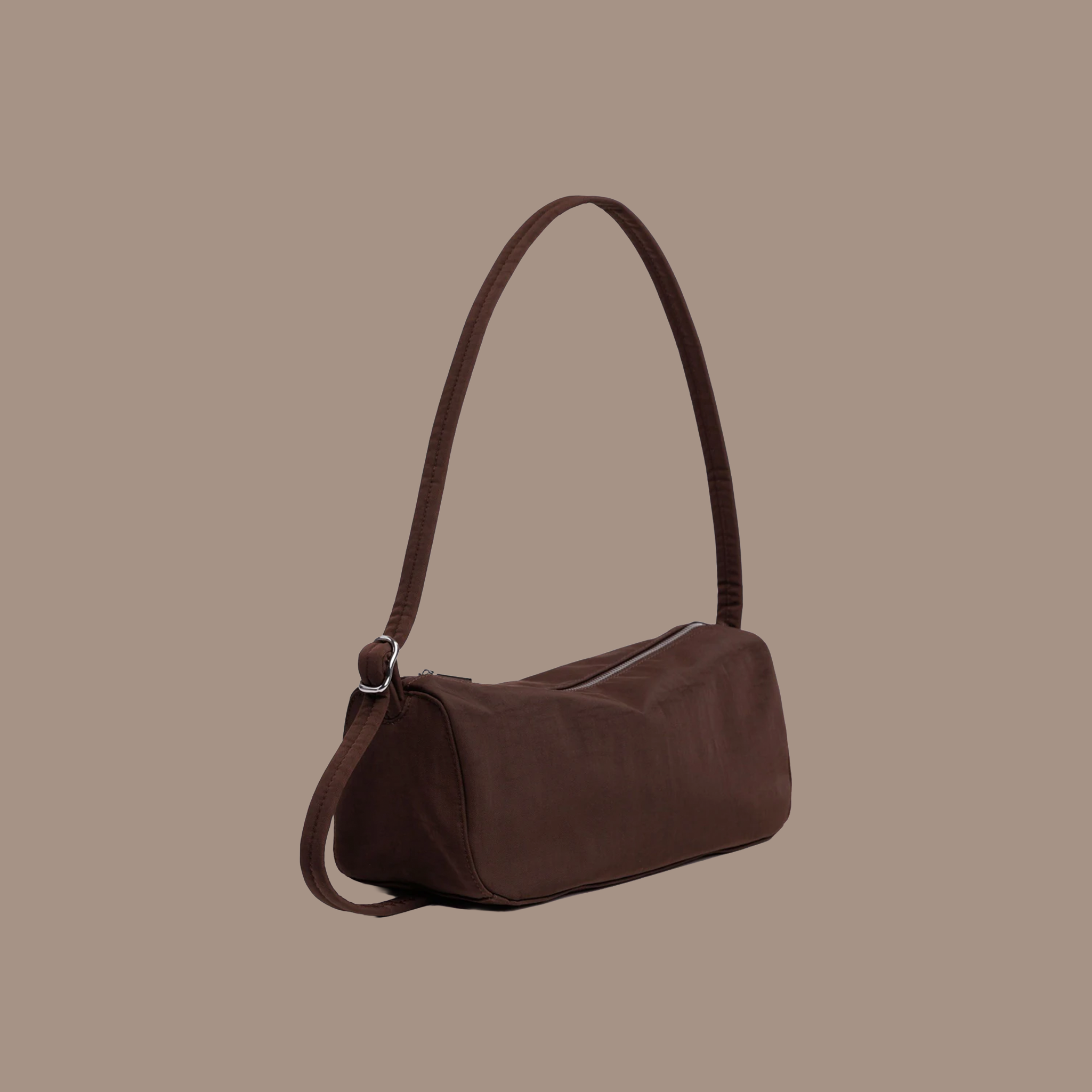 A brown nylon shoulder bag on a brown background.