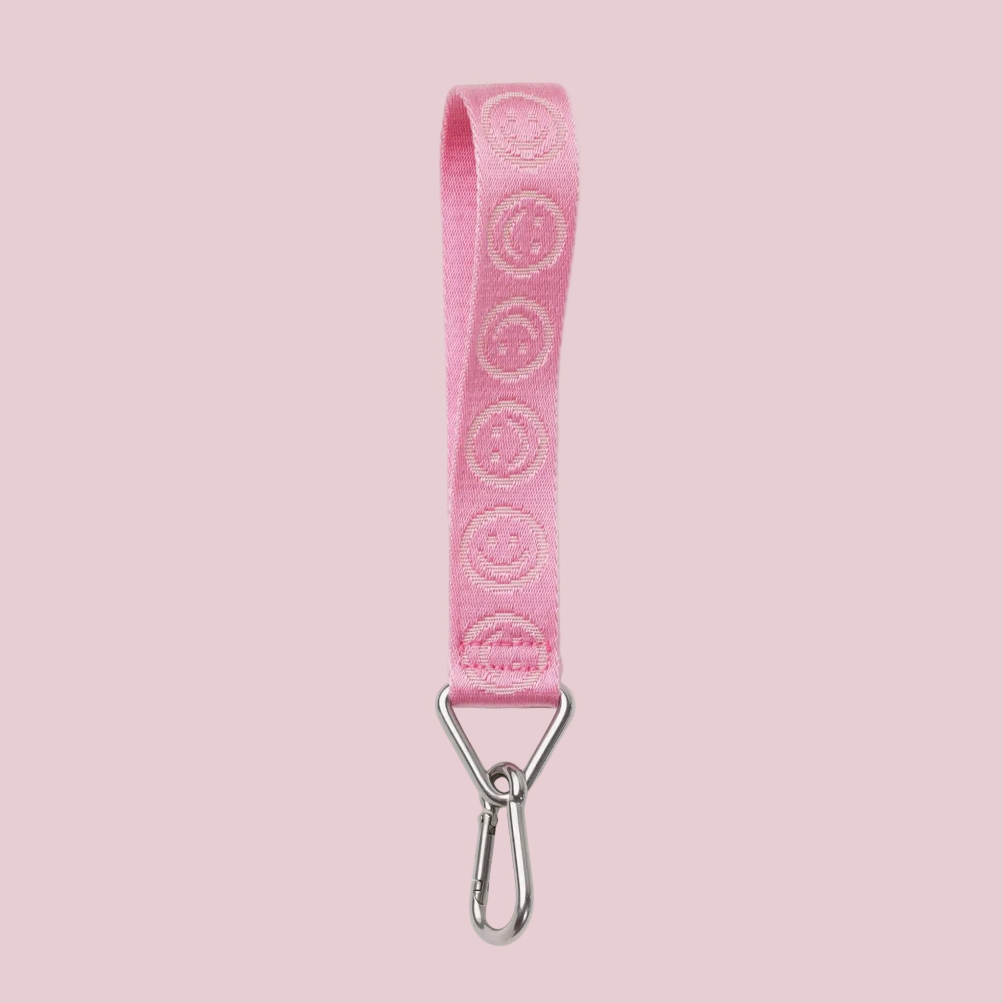 A pink smiley face keychain lanyard. 