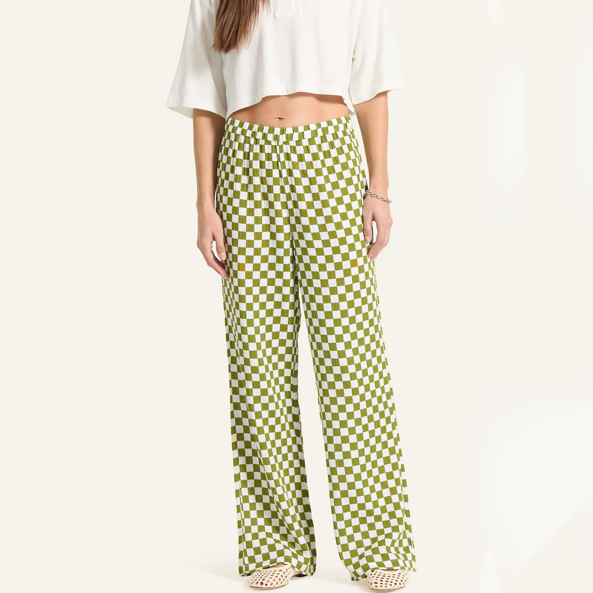 Person wearing green checkered pants on a white background