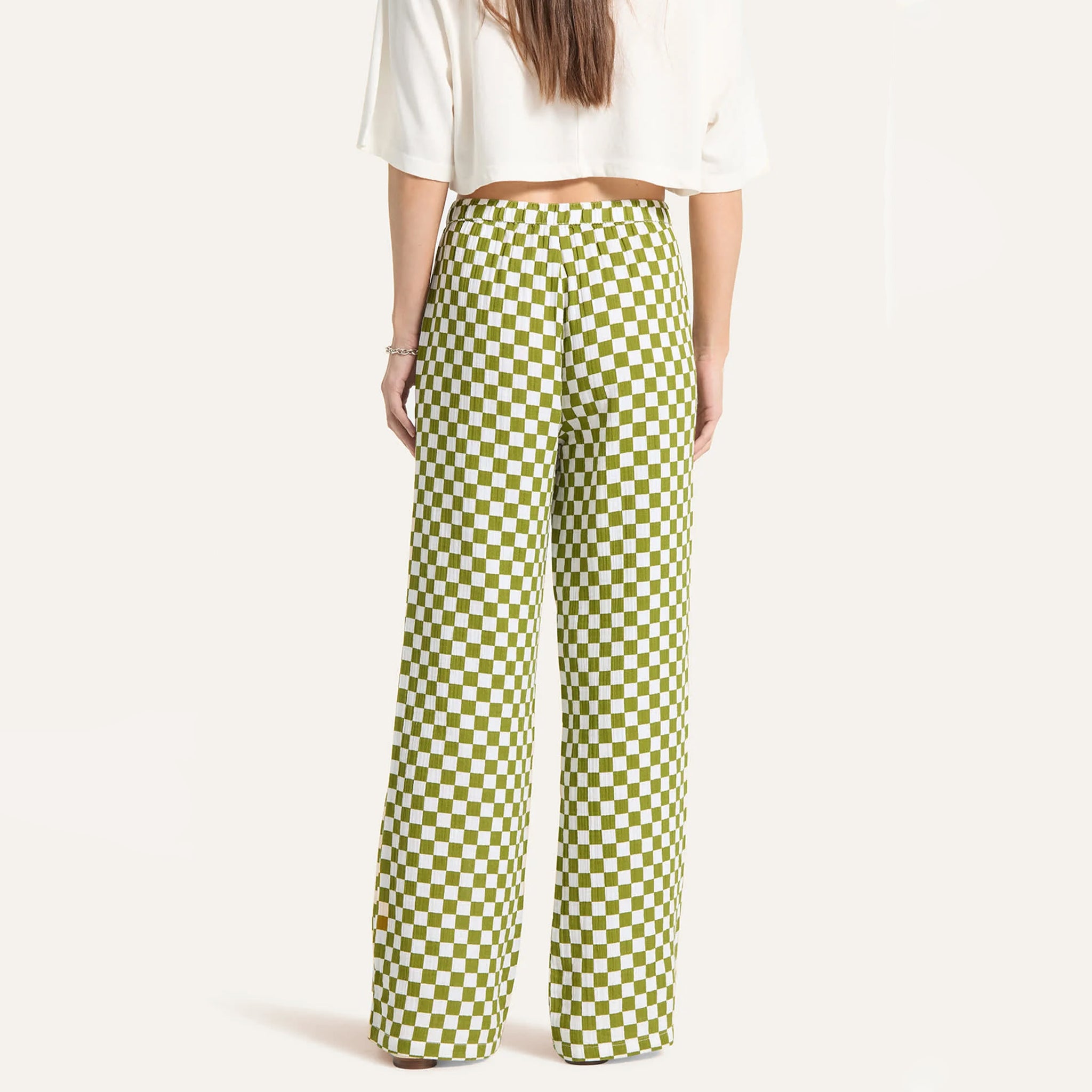 Person wearing green checkered pants on a white background