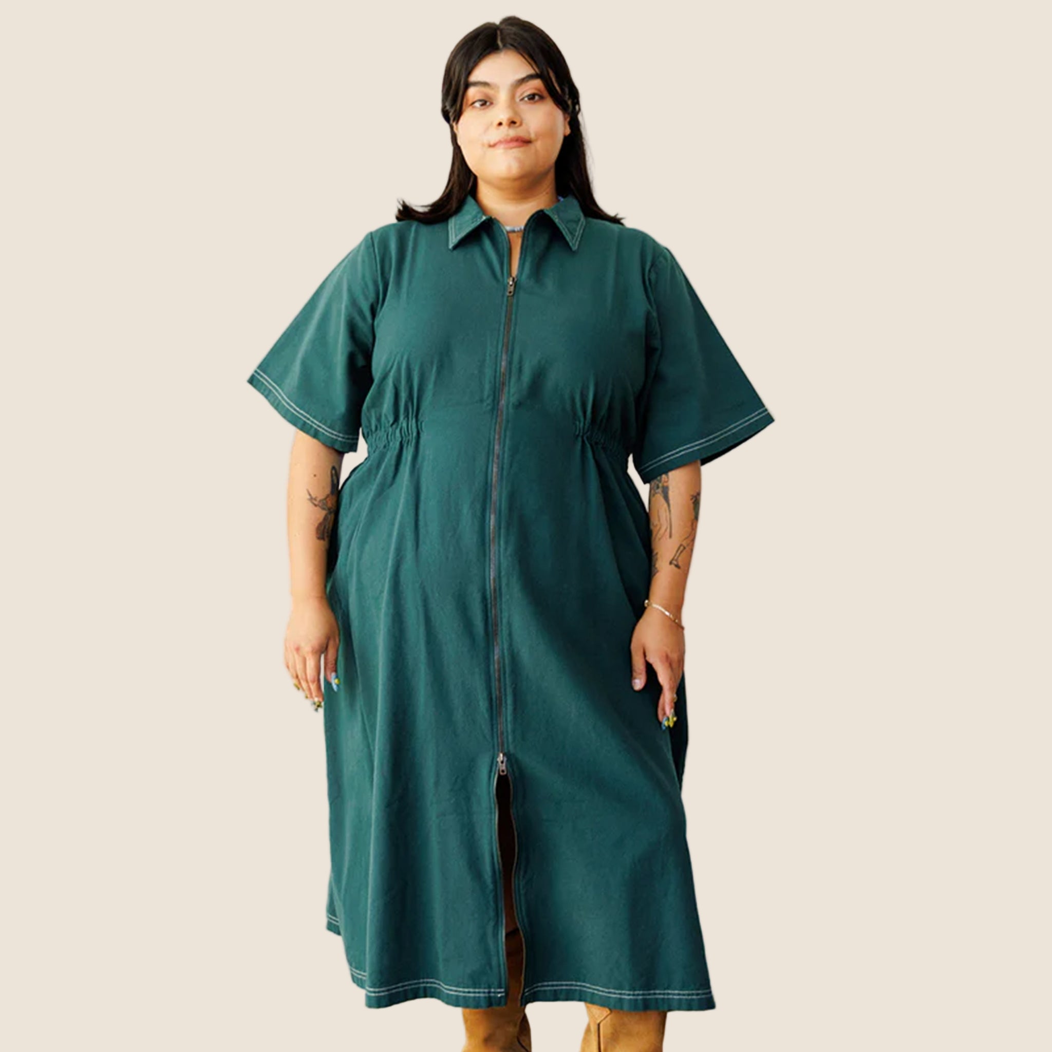 A dark green long utility dress with a zipper and short sleeves.