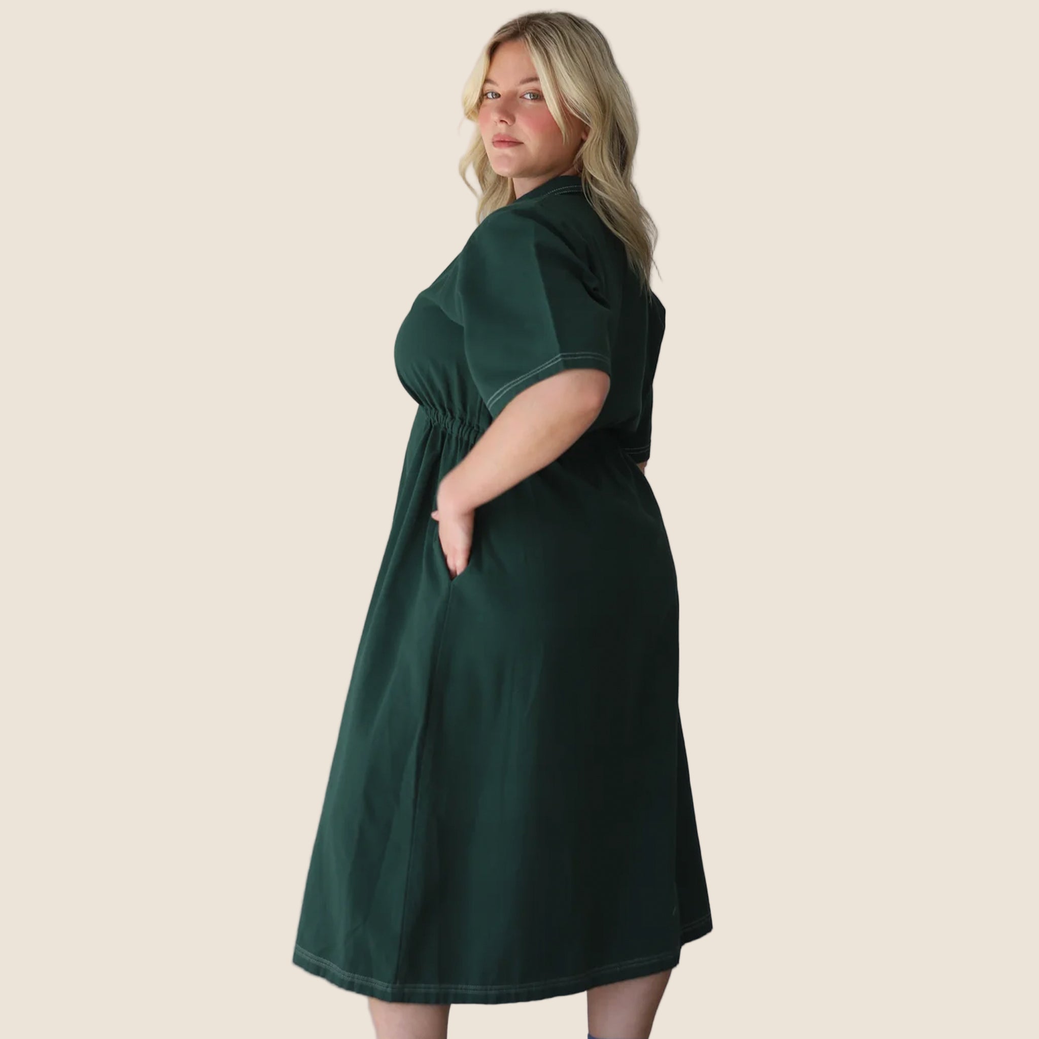 A dark green long utility dress with a zipper and short sleeves.