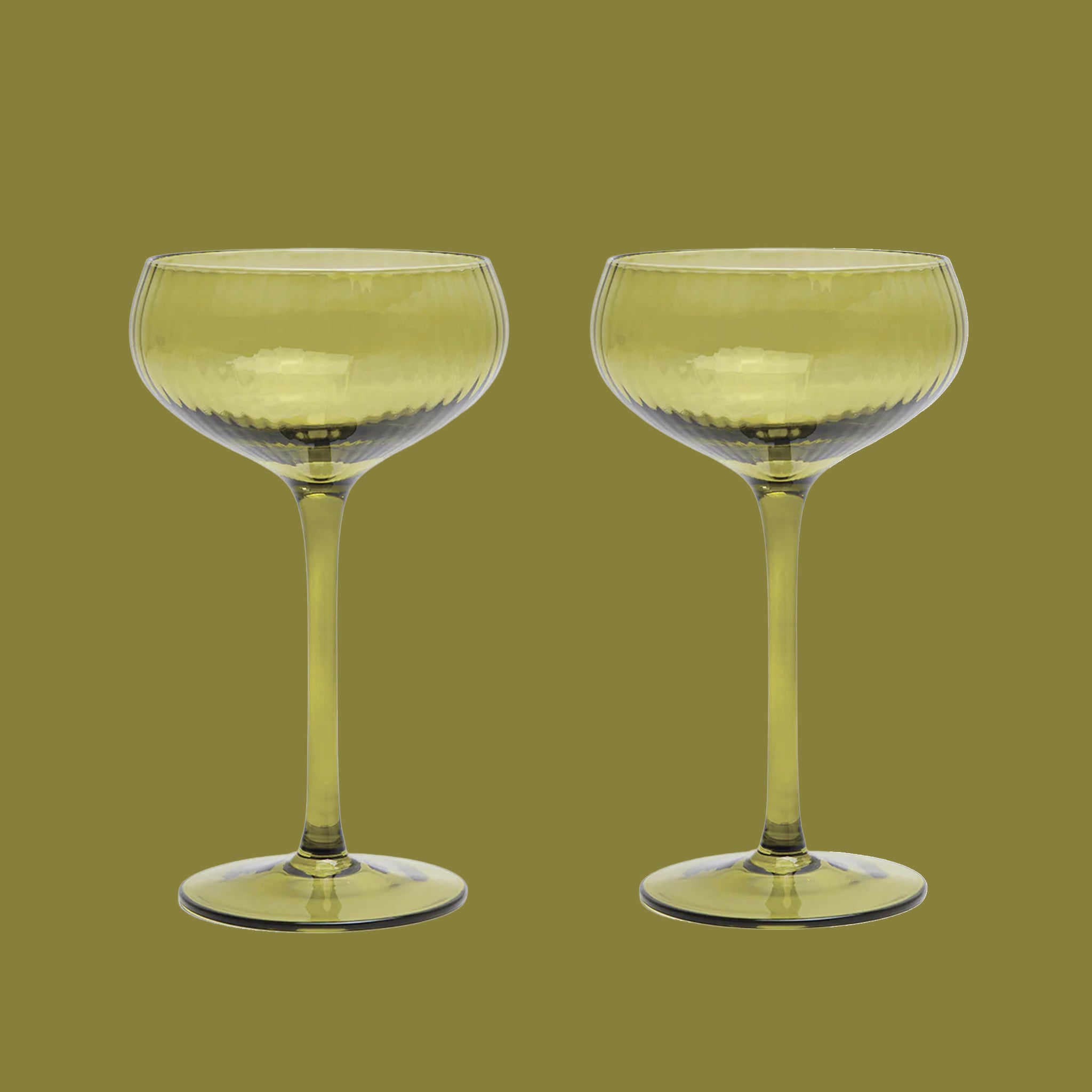An olive green coupe glass. 