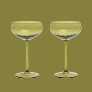 An olive green coupe glass. 