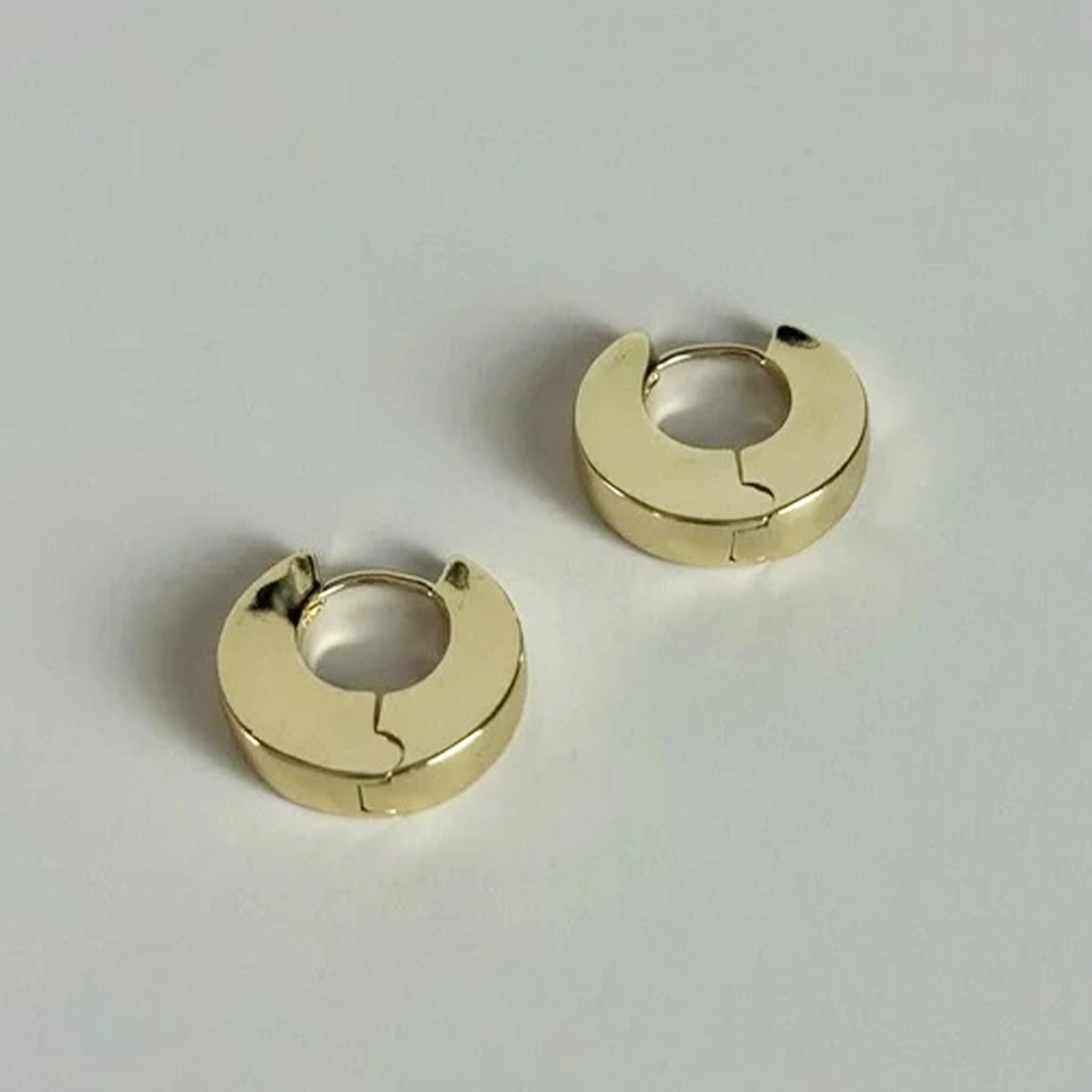 A pair of chunky gold hoop earrings.