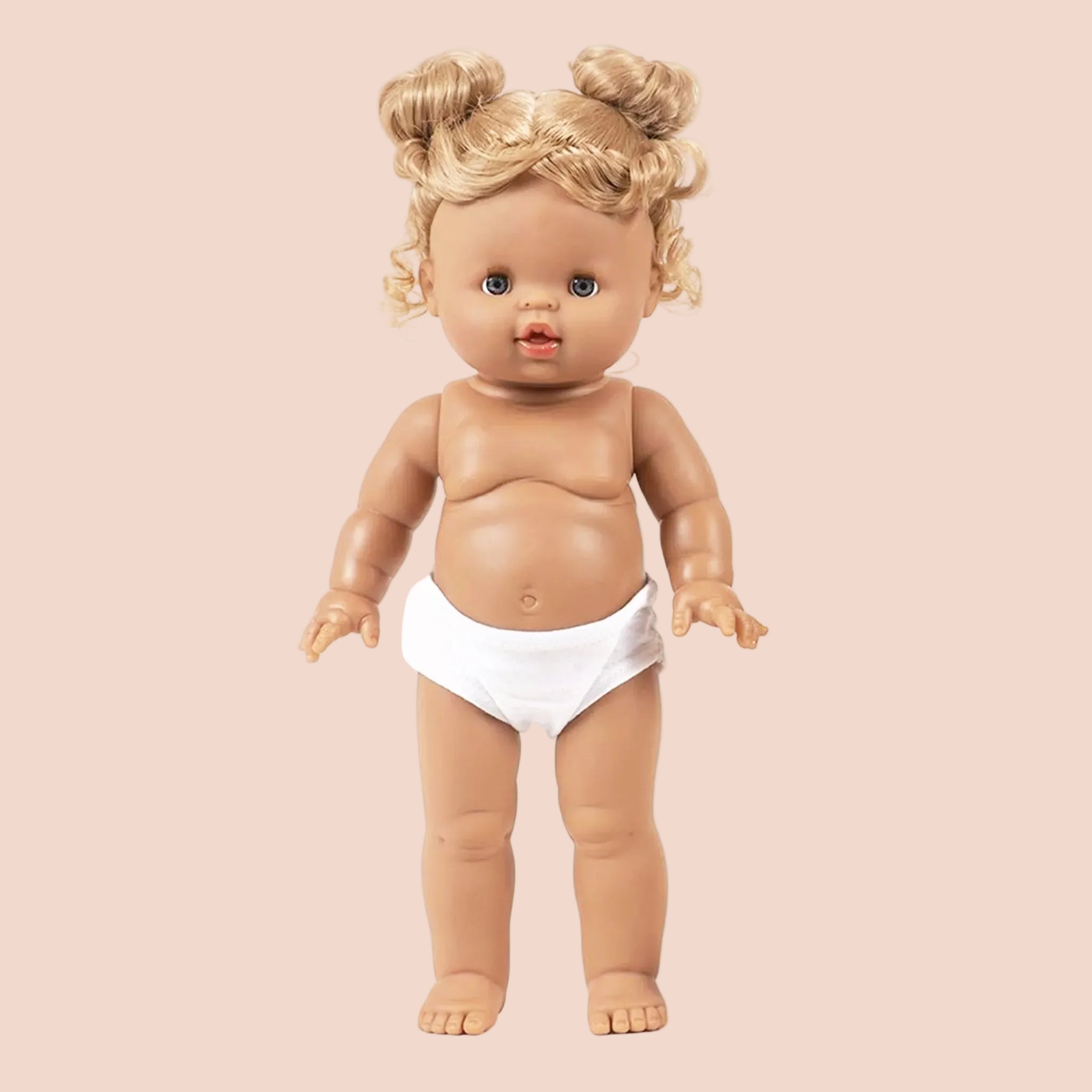 A standing baby doll with space bun blonde hair. Clothing sold separately. 