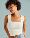Model is wearing a white tank top.