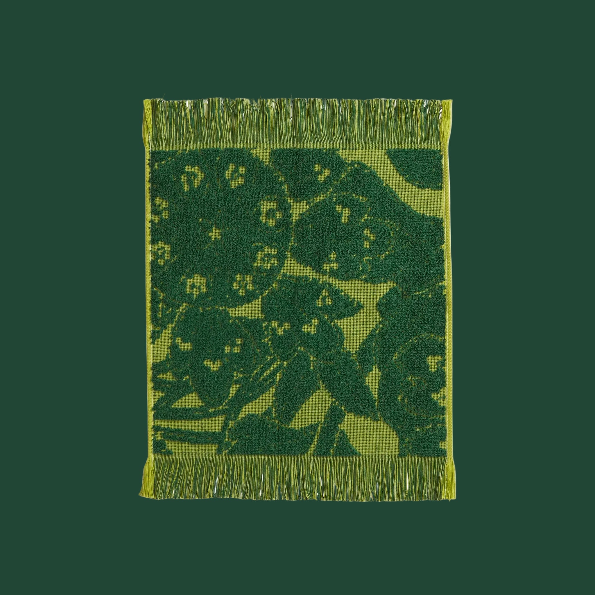  A green floral and leaf print face towel with a fringe edge. 