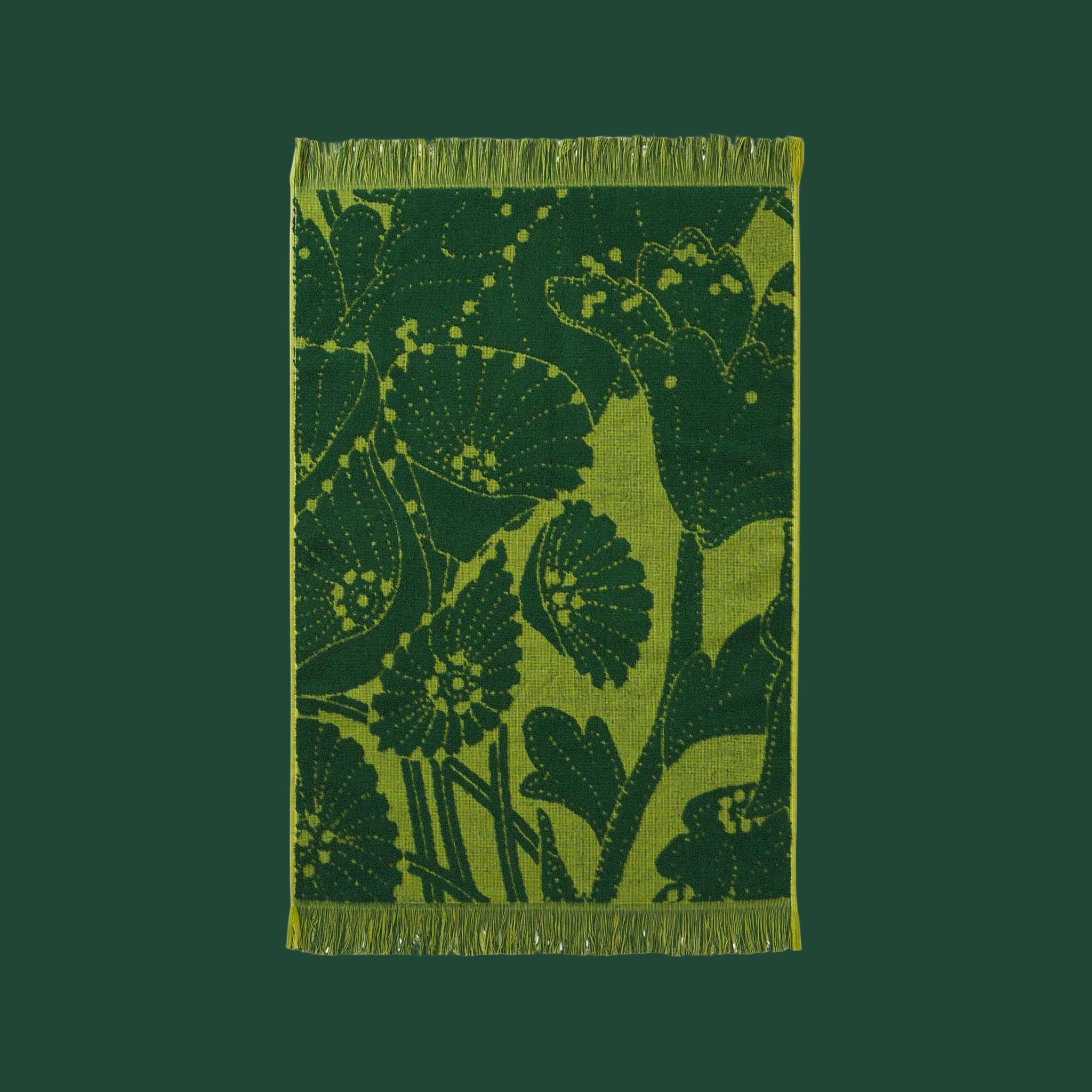 a green hand towel with a floral/leaf print. 