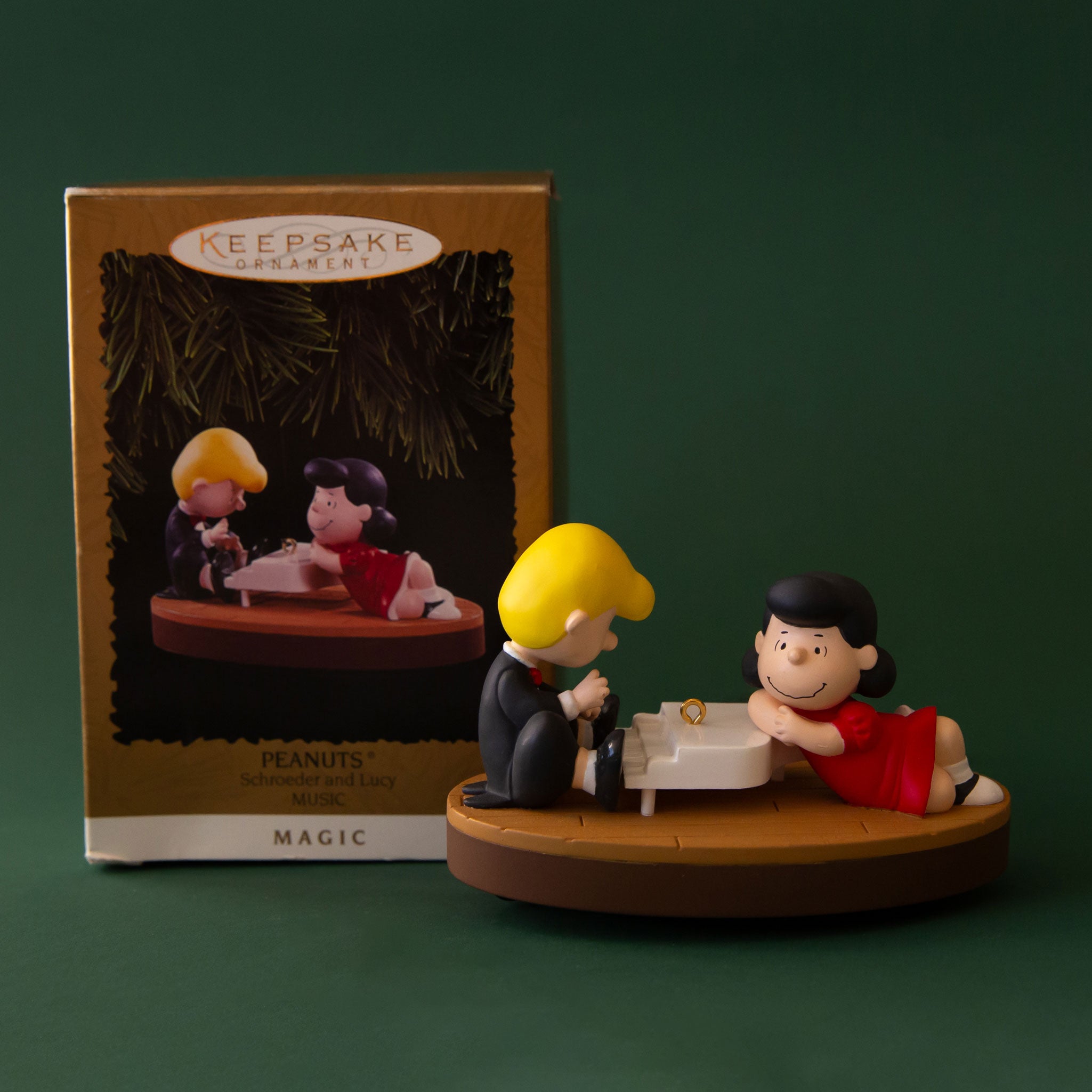 A Shroeder and Lucy vintage ornament with them on a piano.
