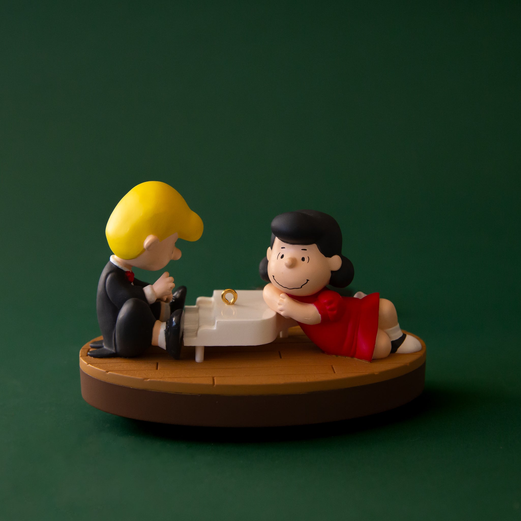 A Shroeder and Lucy vintage ornament with them on a piano.