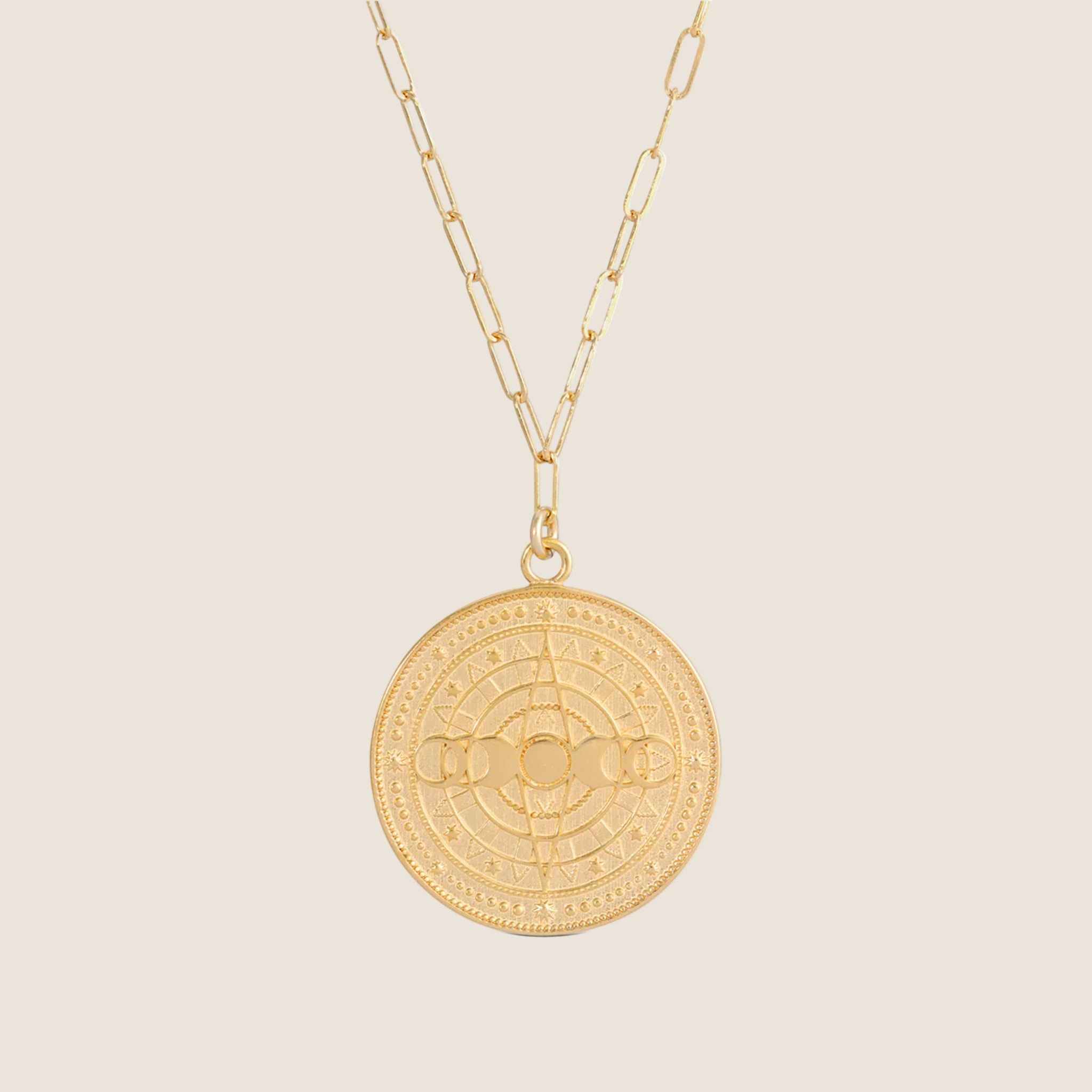 A coin pendant necklace with the lunar phases on. 