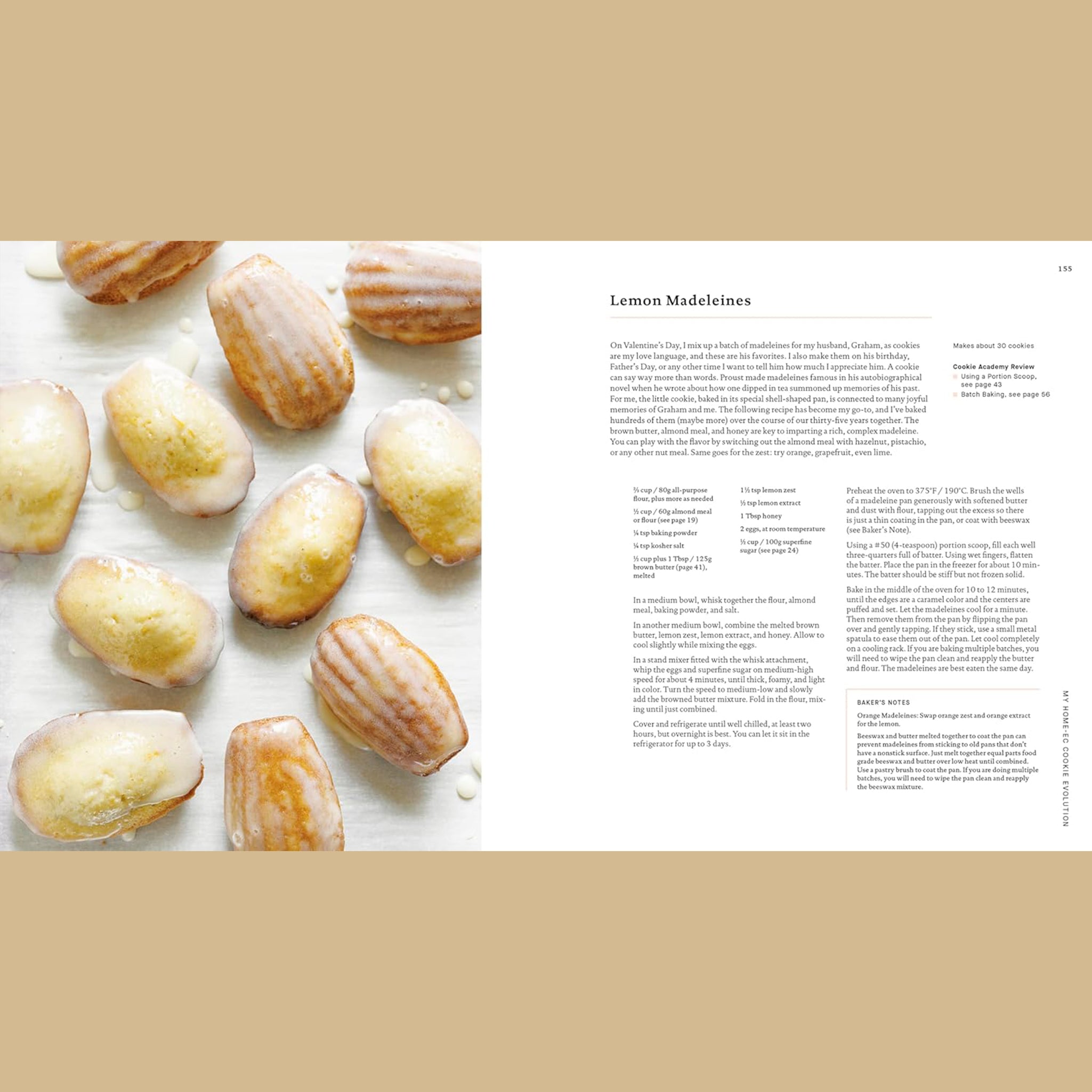 Open cookbook spread featuring a recipe for lemon madeleines, with a photo on the left of small shell-shaped cakes glazed and arranged on a light surface, and recipe text on the right.