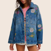 A jean jacket with floral embroidery. 