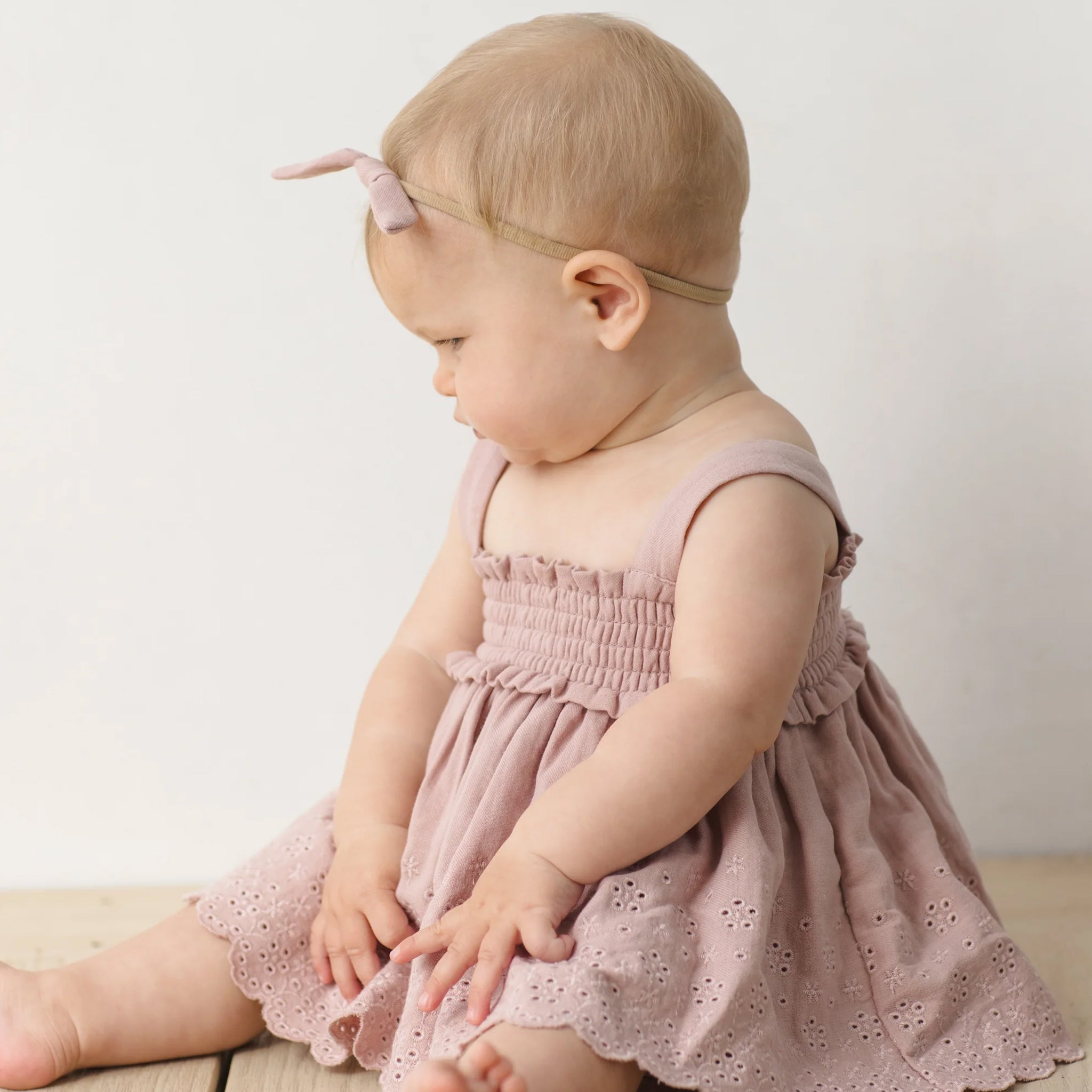 A light pink smocked top and bloomer eyelet set for babies and kids. 