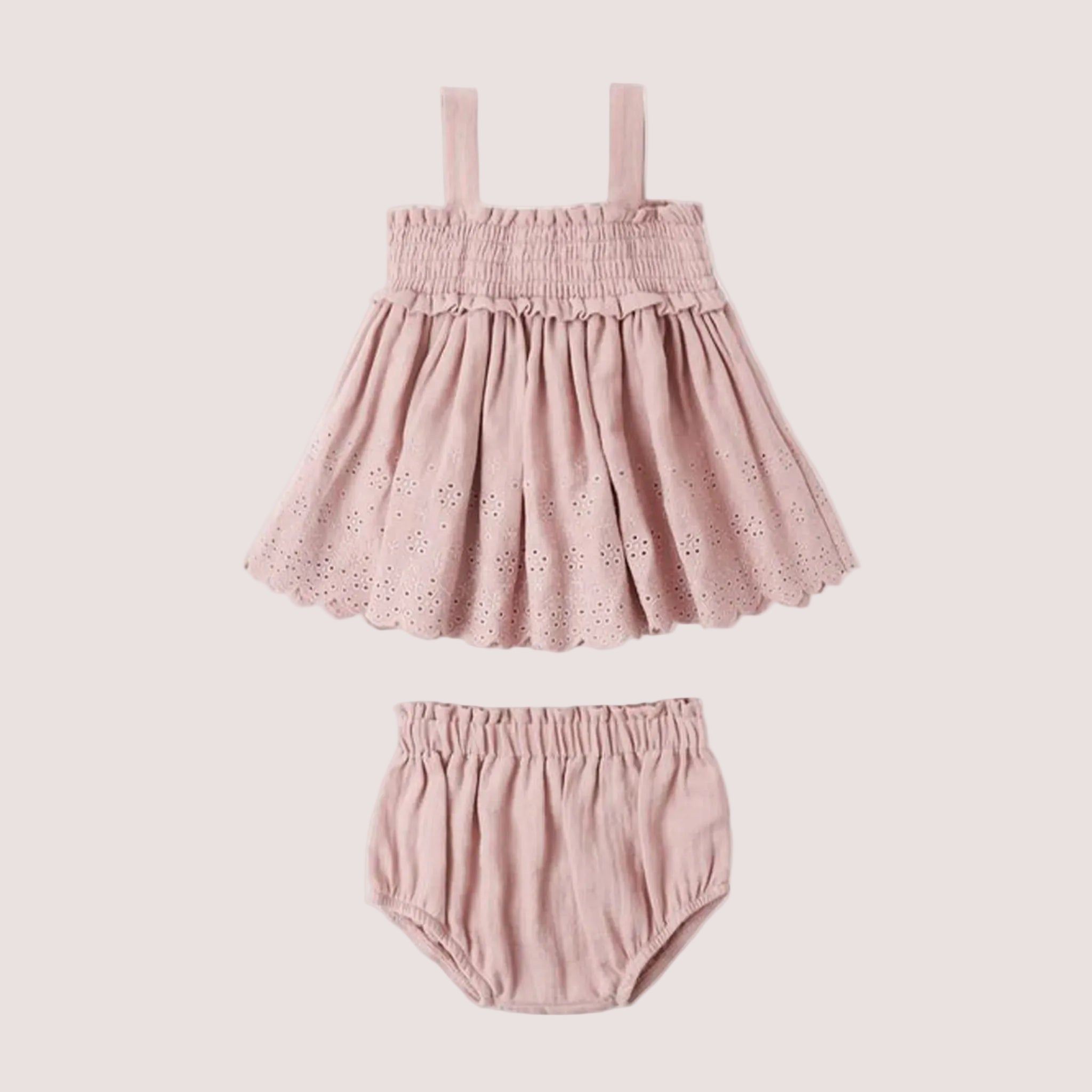 A light pink smocked top and bloomer eyelet set for babies and kids. 