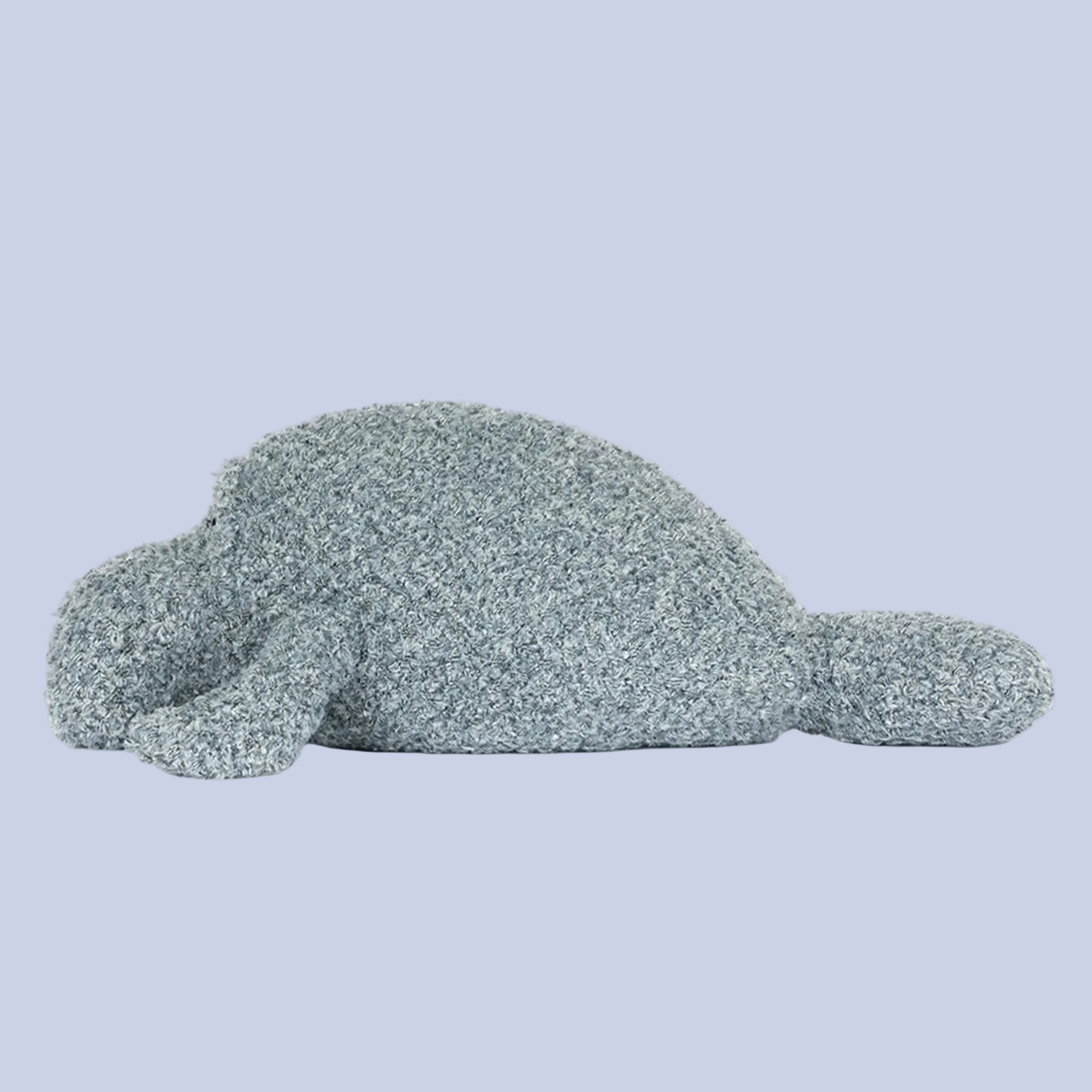 Plush toy manatee on a white background
