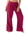On a white background is a model wearing magenta wide leg cotton pants with an elastic drawstring.  Edit alt text