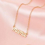 A dainty chain necklace with a small "mama" charm.