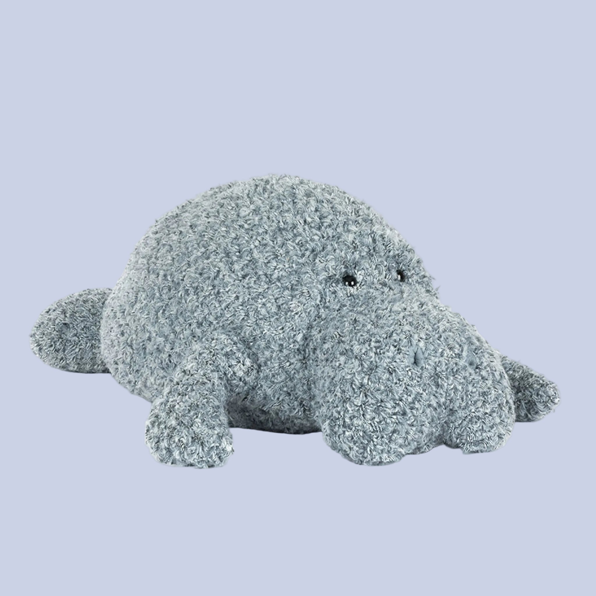 Plush toy manatee on a white background