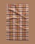 A brown, orange and tan plaid tea towel. 