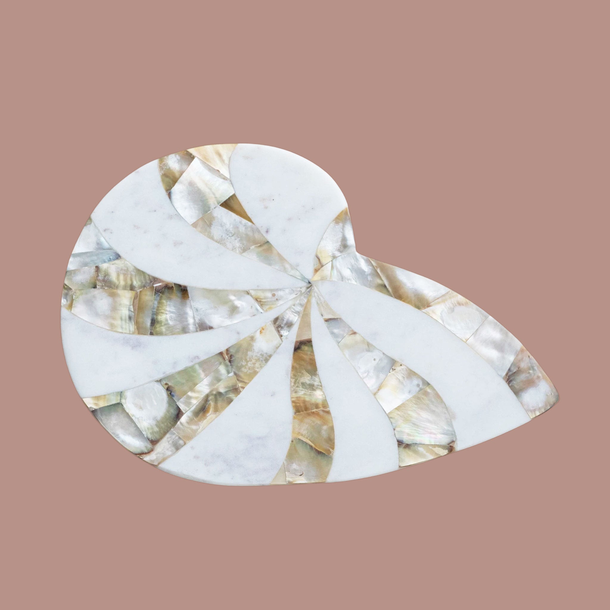 A shell shaped cutting board with mother of pearl details. 