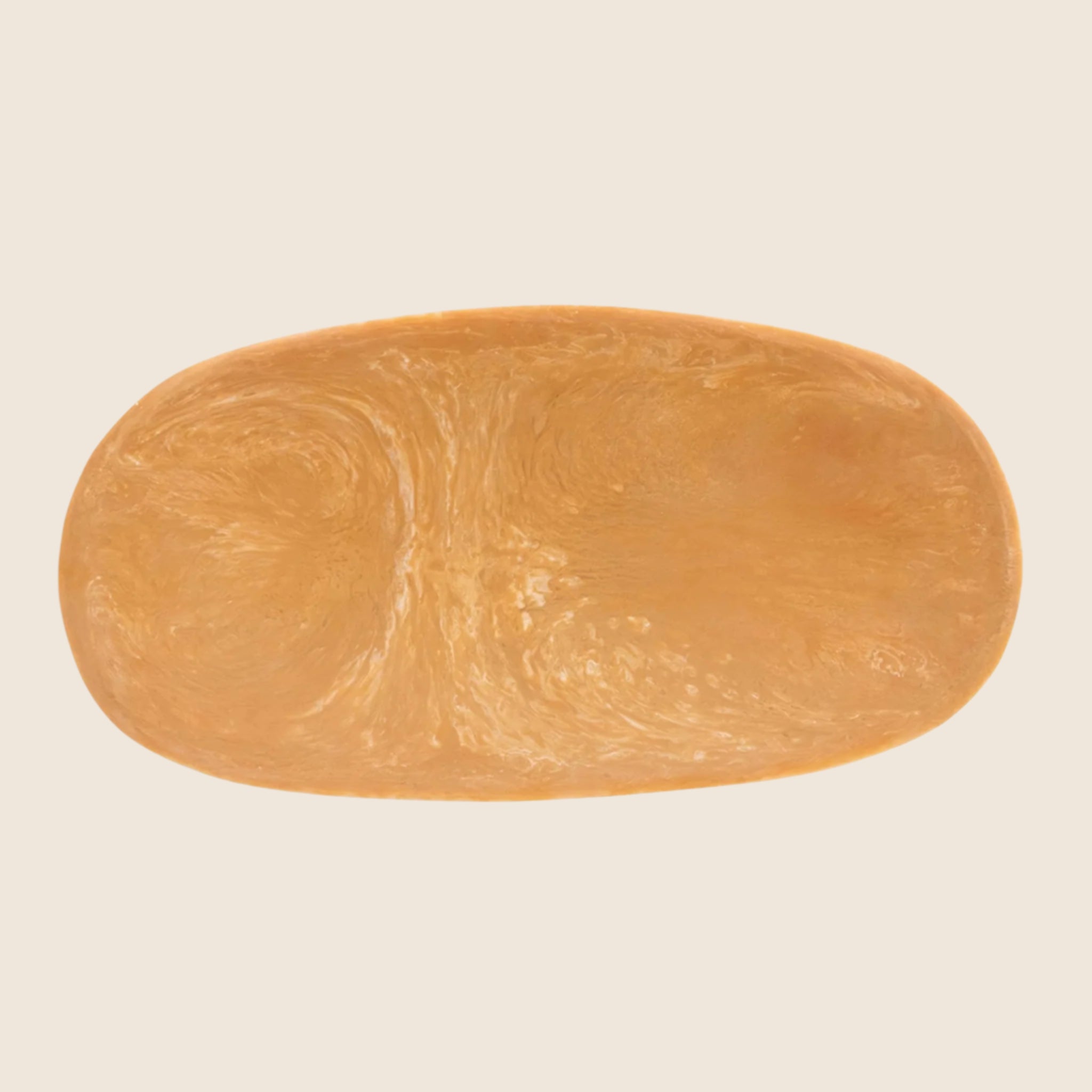 A light brown resin serving platter or decorative tray. 