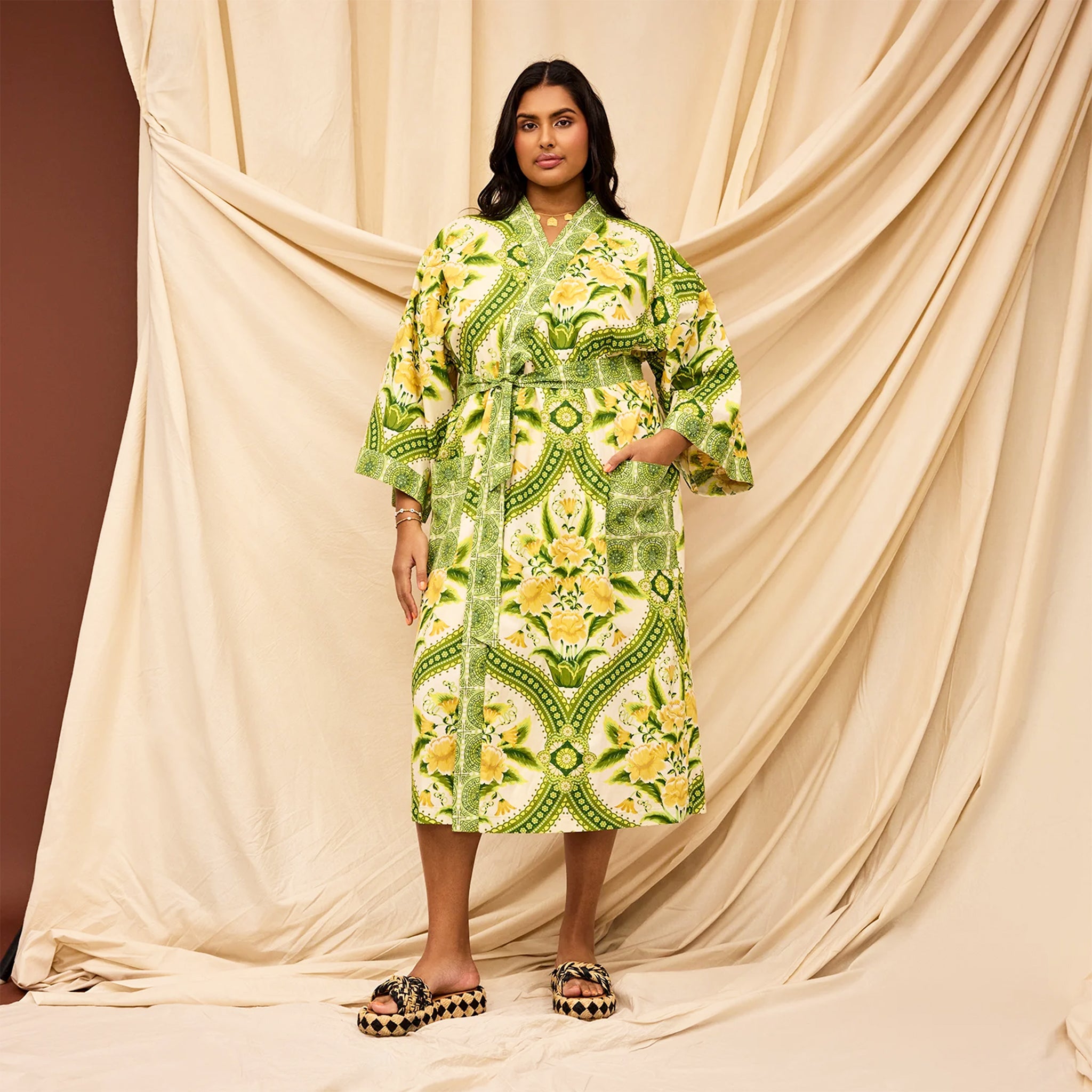 A green and yellow floral print robe. 