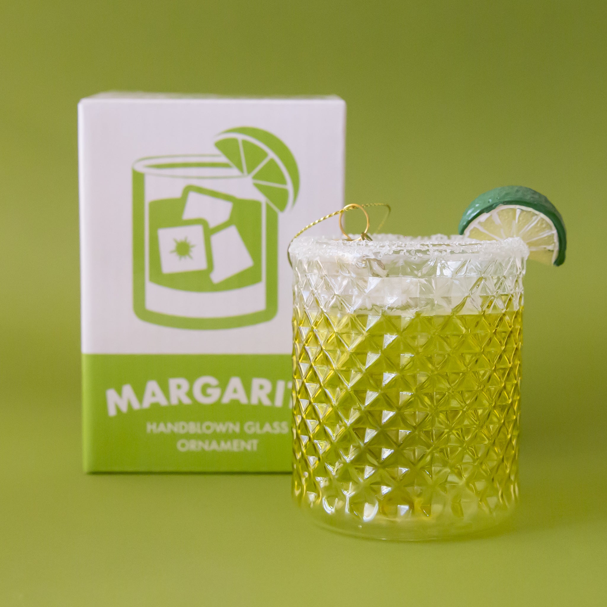 A glass margarita shaped ornament with a salt rim and lime slice. 