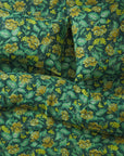 A green and yellow floral print duvet cover. 