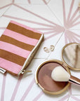 A pink and orange striped coin purse. 