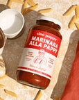 A glass jar of marinara sauce with white text that reads, 'ciao pappy Marinara Alla Pappy'. 