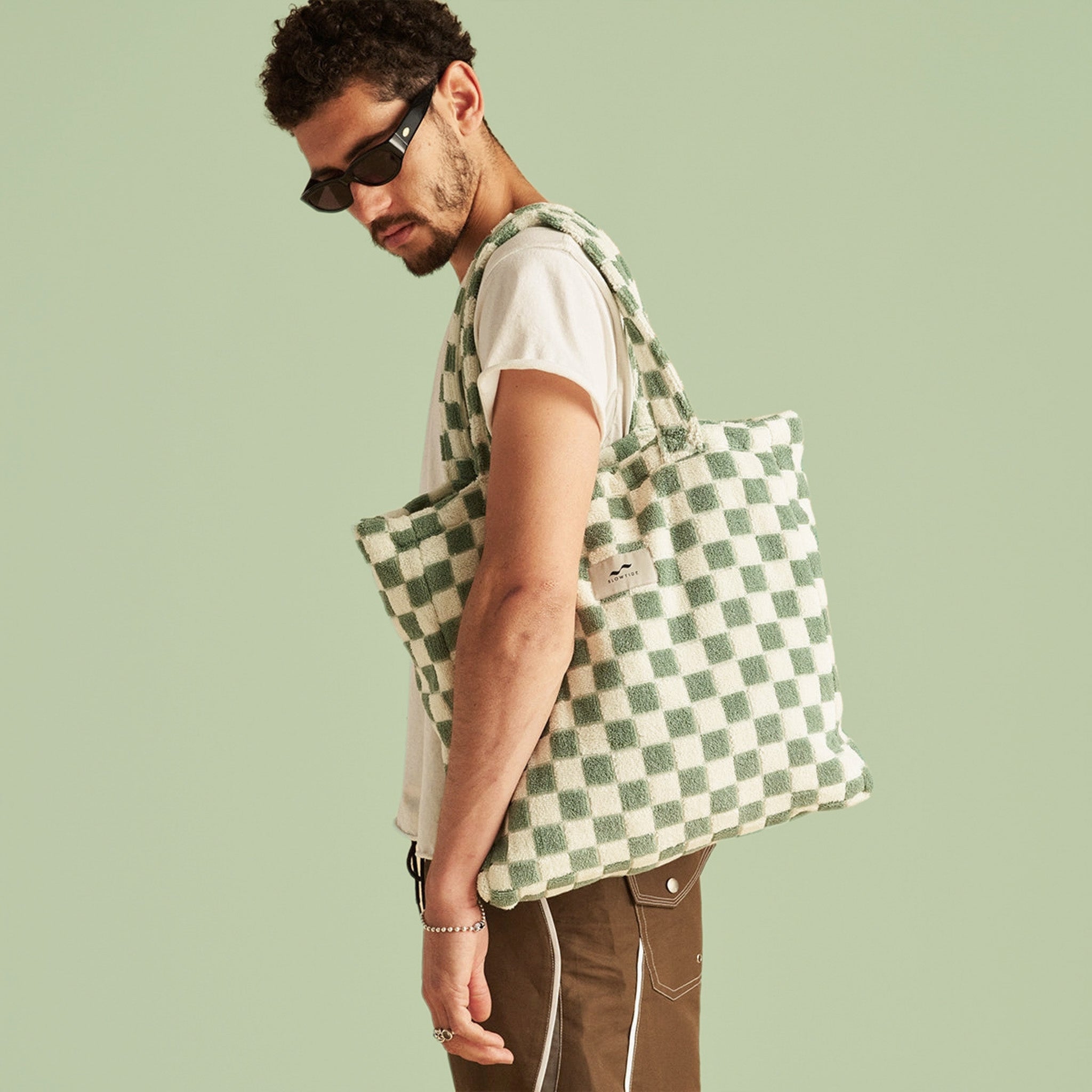 A green and cream checker print tote bag with a terry towel texture. 