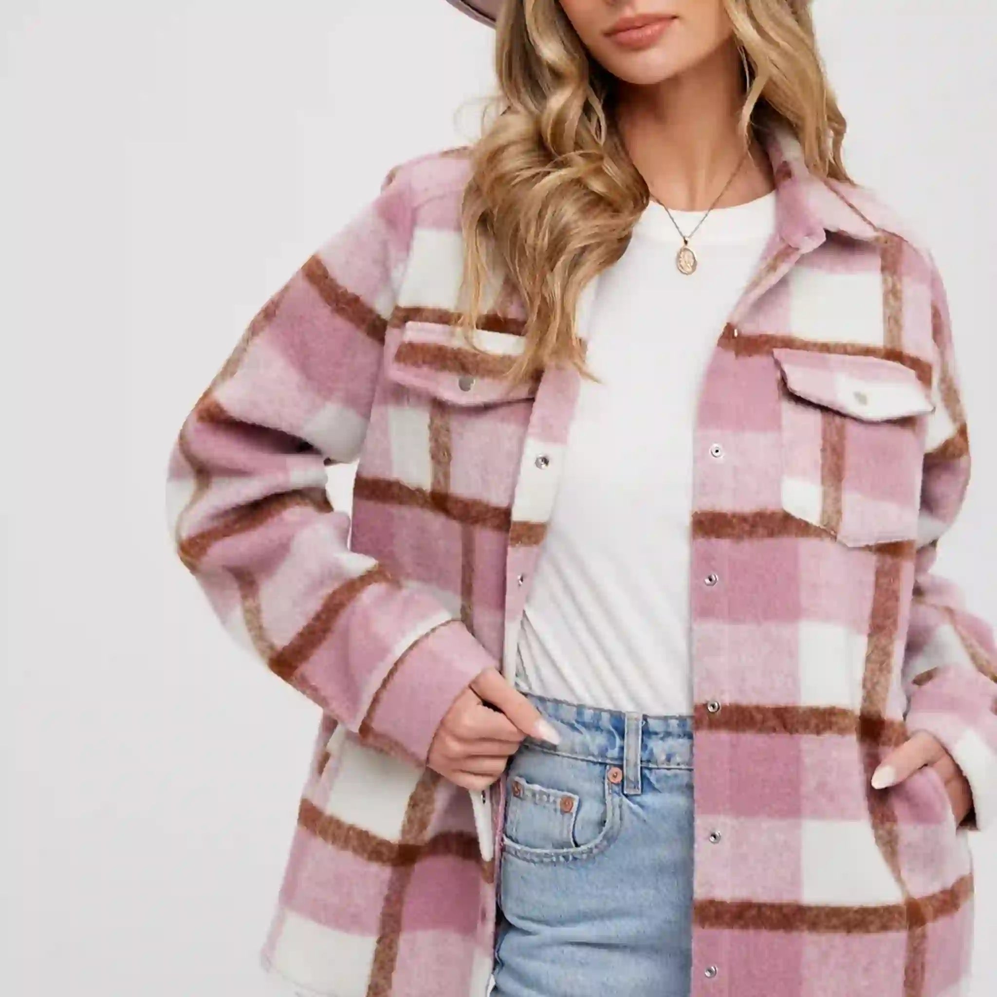 On a white background is a pink and white plaid shacked with front pockets.