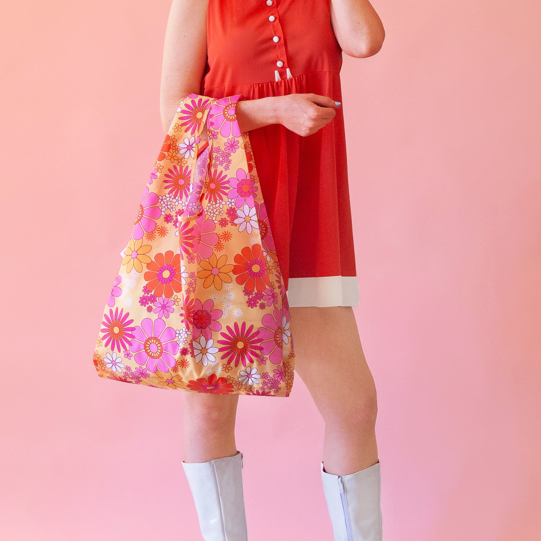 A pink floral print nylon reusable bag.