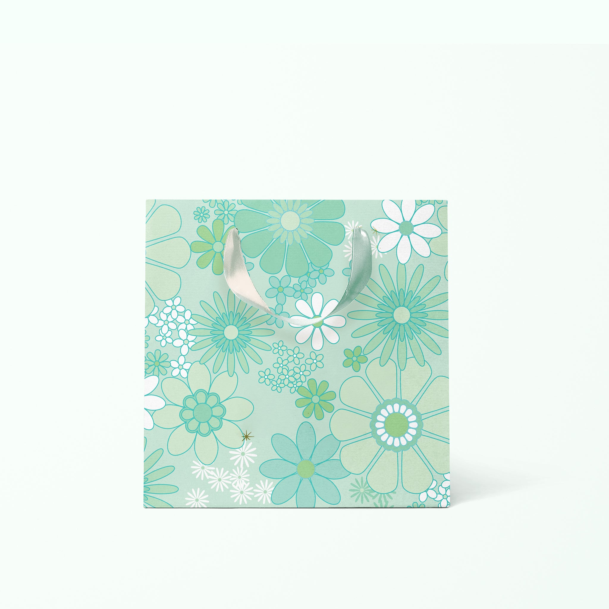 On a white background is a rendering of the small gift bag with a mint and white floral print and ribbon handles.
