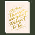 A cream card with gold foiled words that read, "Some things are just meant to be. Congratulations" alongside a matching white envelope.