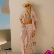 A pair of eyelet chalk pink wide leg trouser pants. 