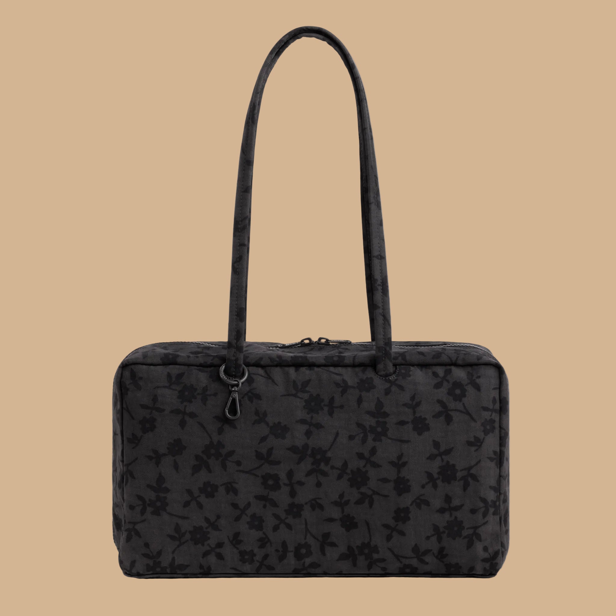A black rectangular tote bag with a subtle floral pattern, featuring dual top handles and a top zipper closure