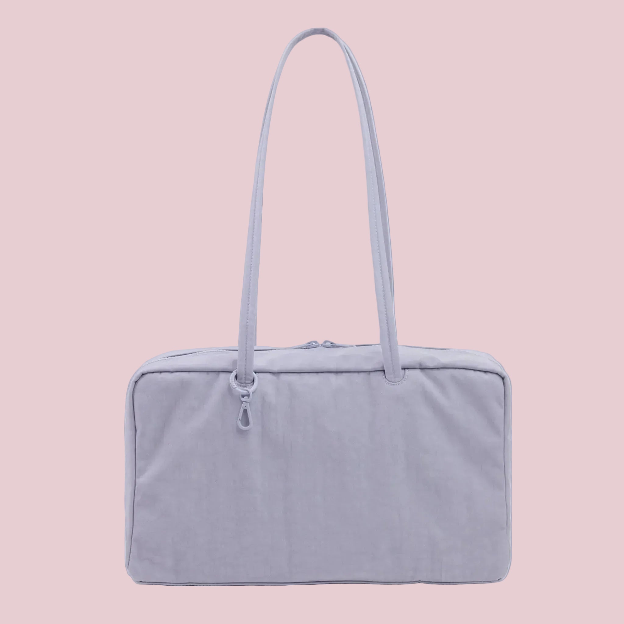 A light blueish-purple nylon rectangle shaped shoulder bag. 