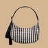 A black and cream gingham print shoulder bag.