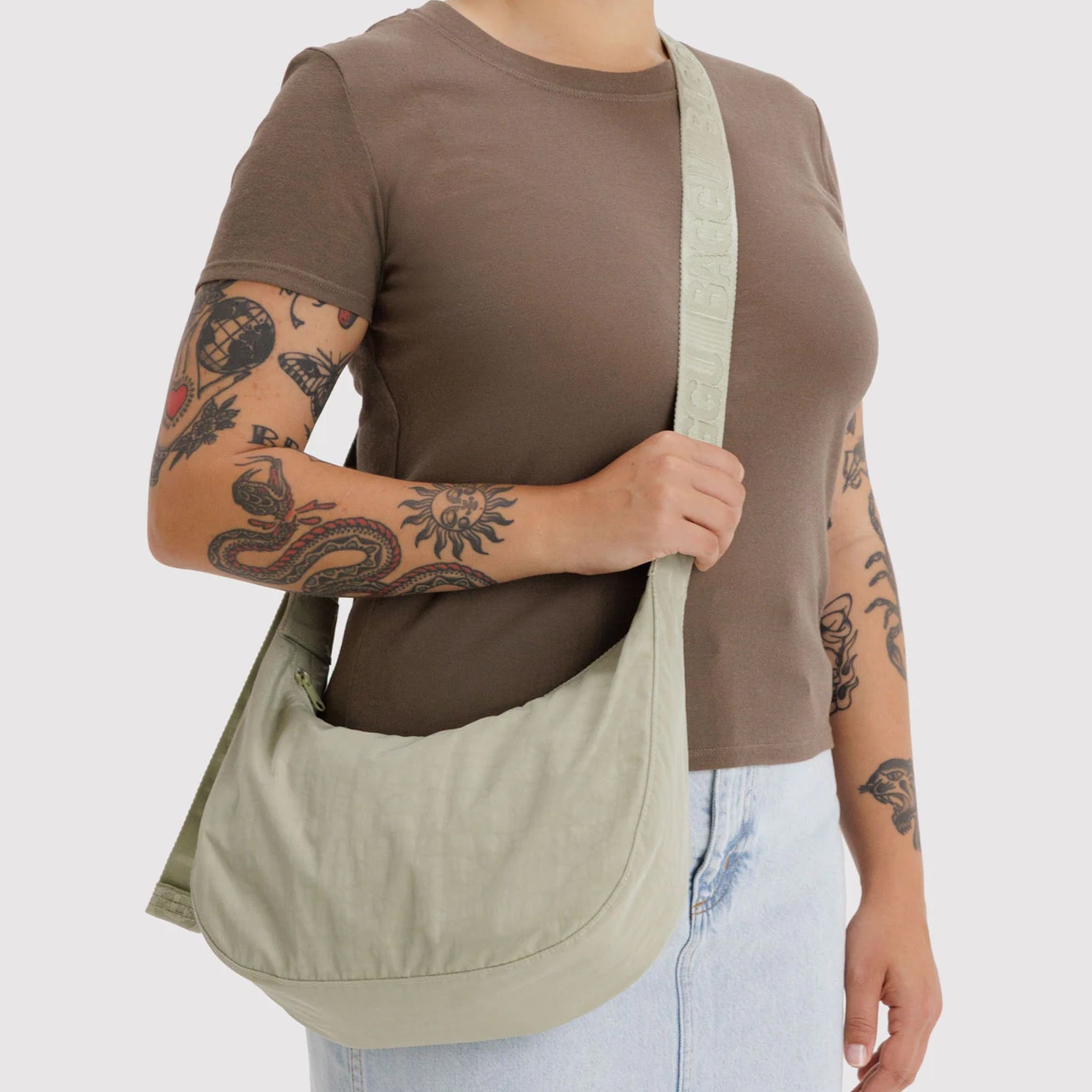 A super pale green nylon crescent shaped shoulder bag. 