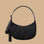 A charcoal crescent bag with a black floral print.