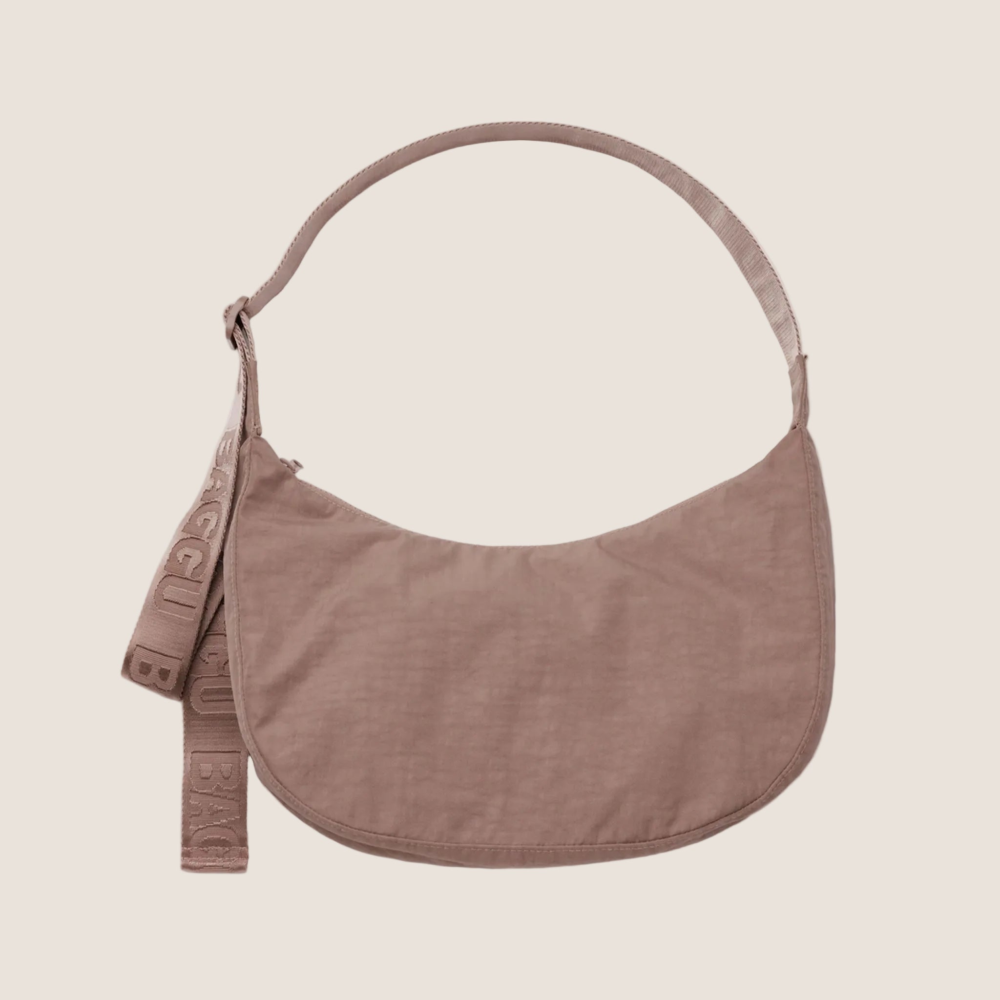 A mauve crescent shaped purse. 