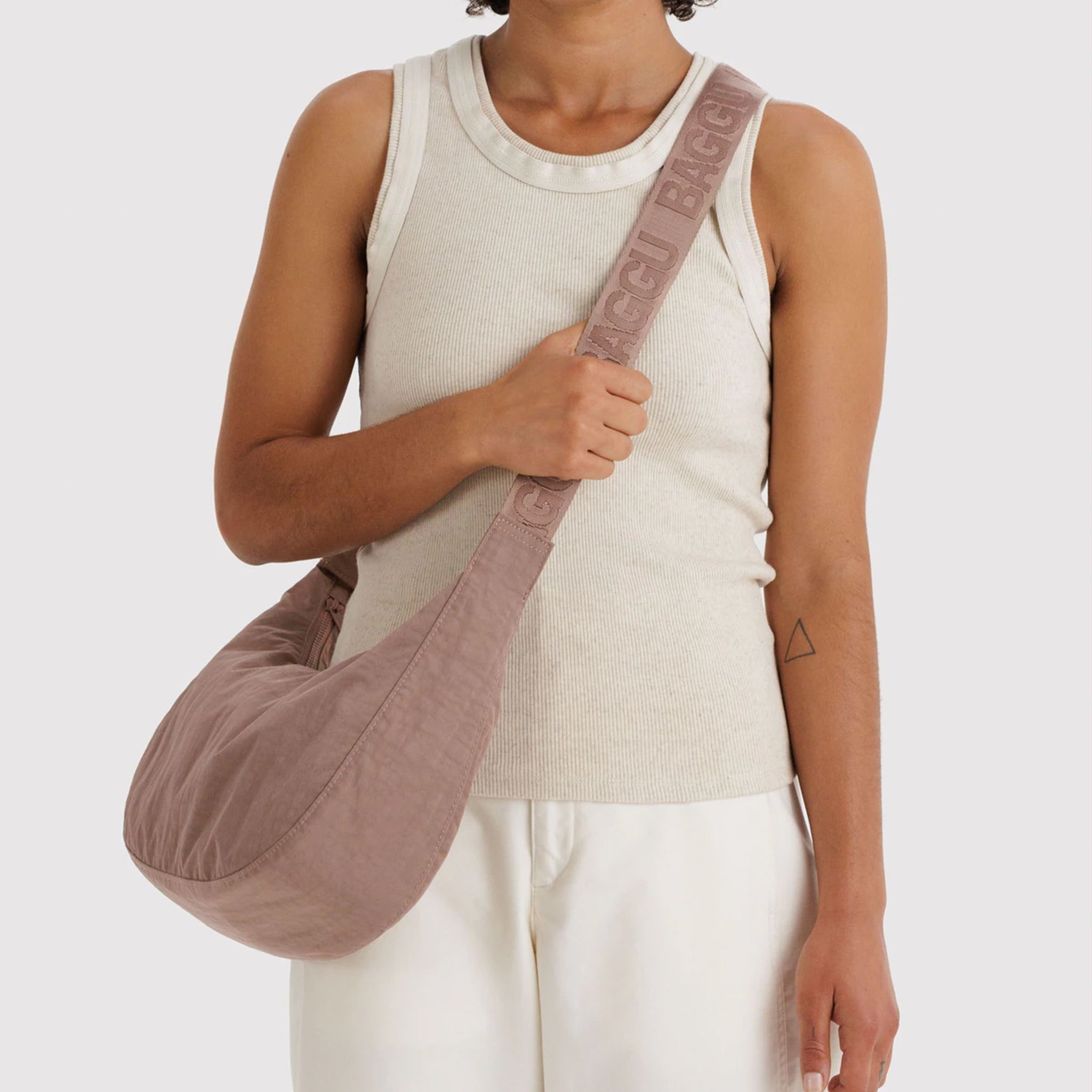 A mauve crescent shaped purse. 