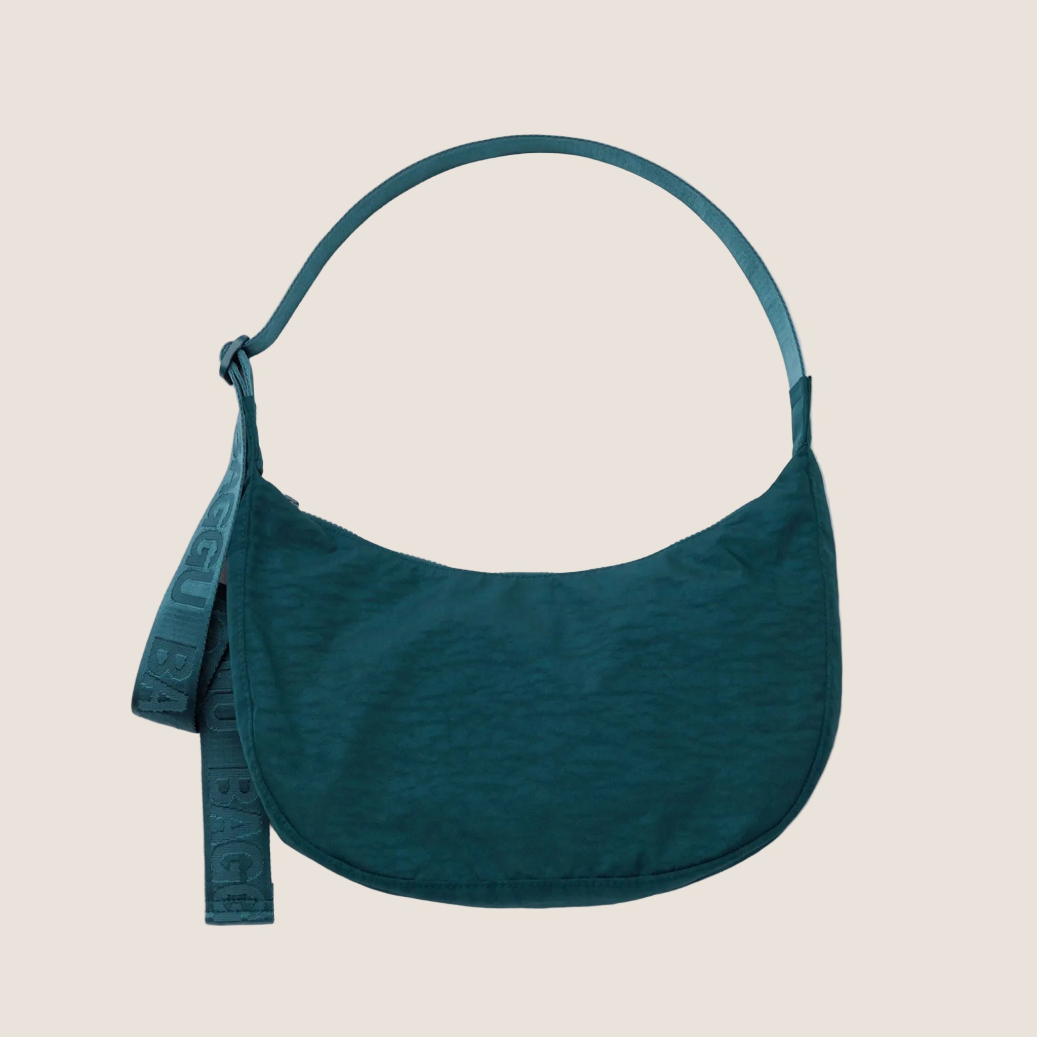 A dark teal colored crescent shaped purse. 