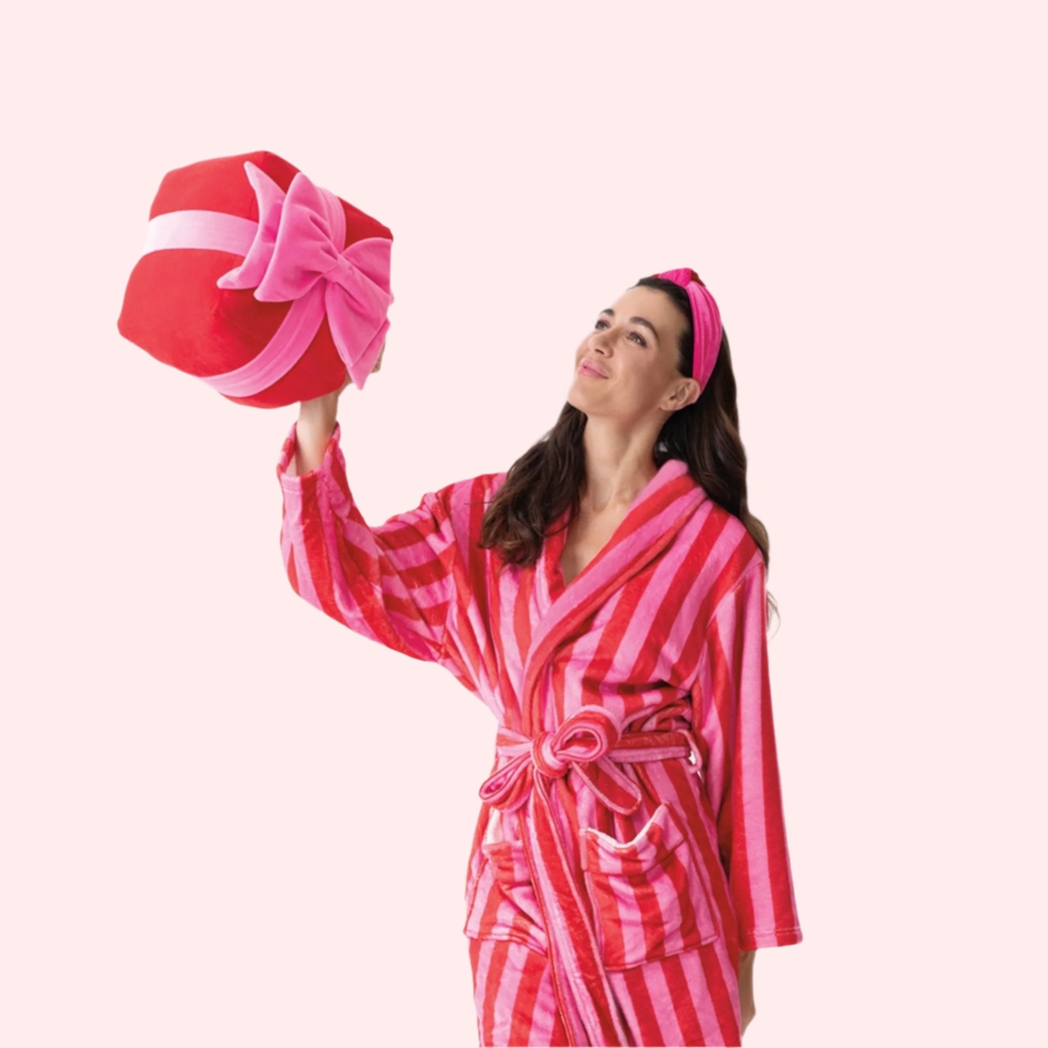 A model holding the medium gift box pillow.