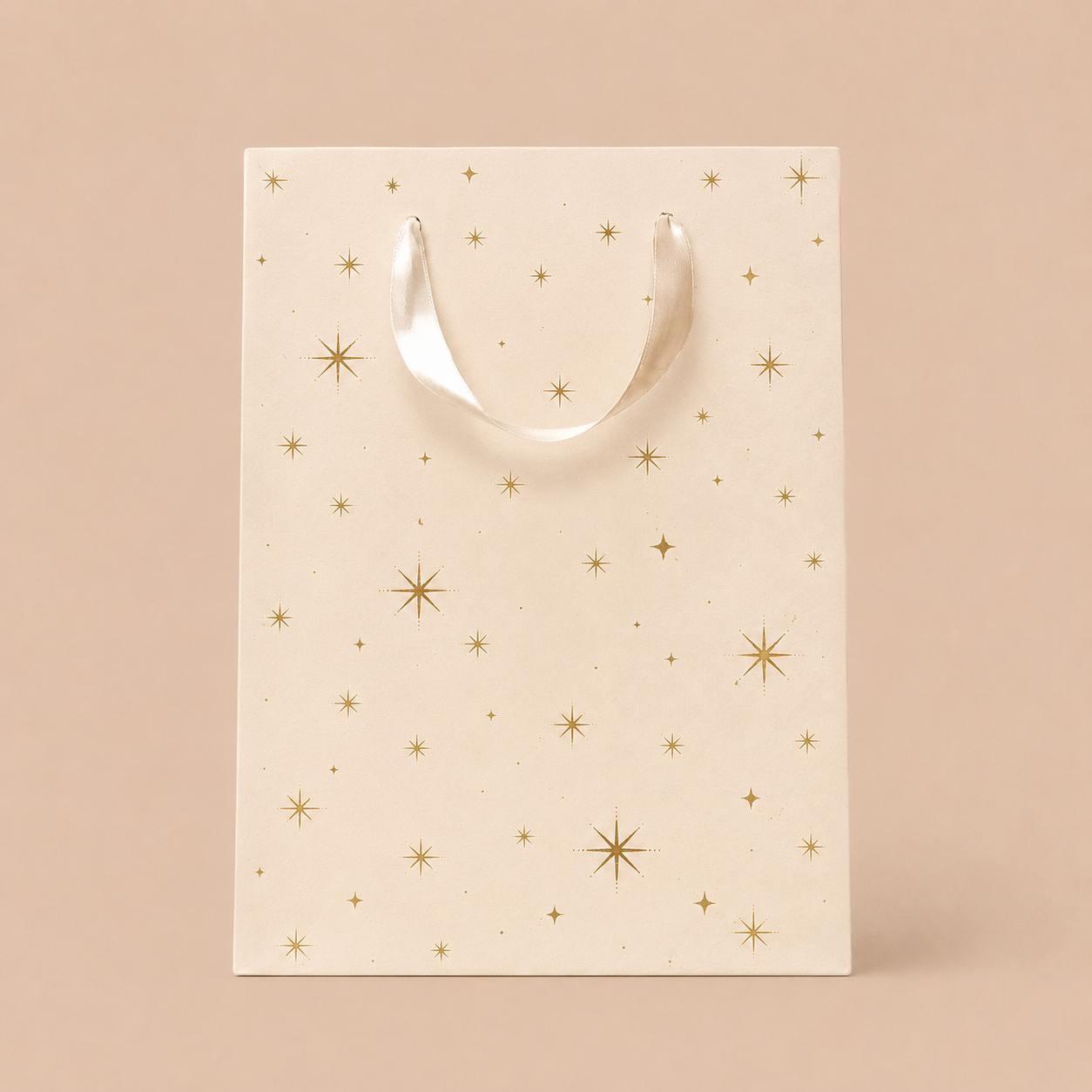 On an ivory background is a light pink gift bag with gold star details.