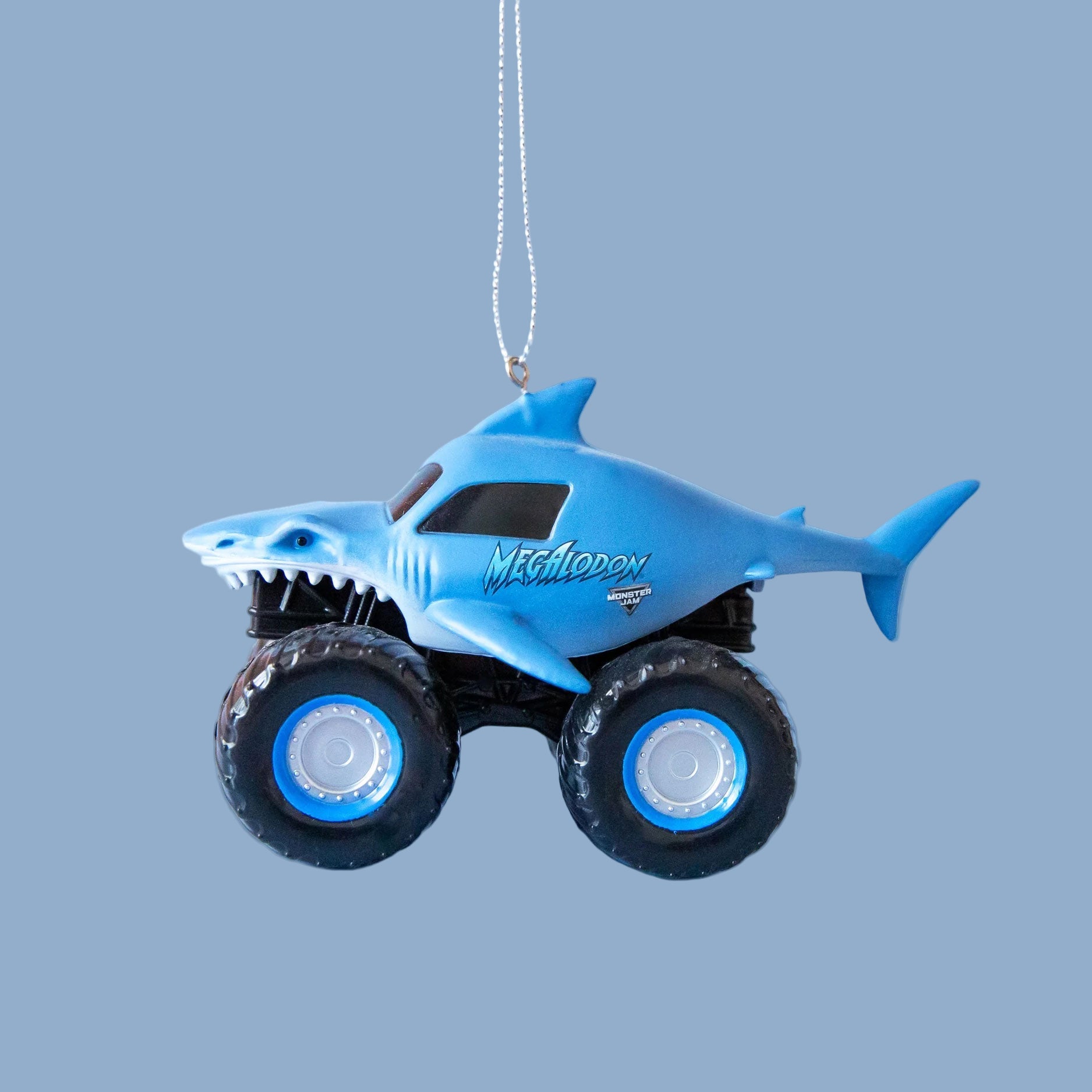 A blue Megalodon monster truck shaped ornament.