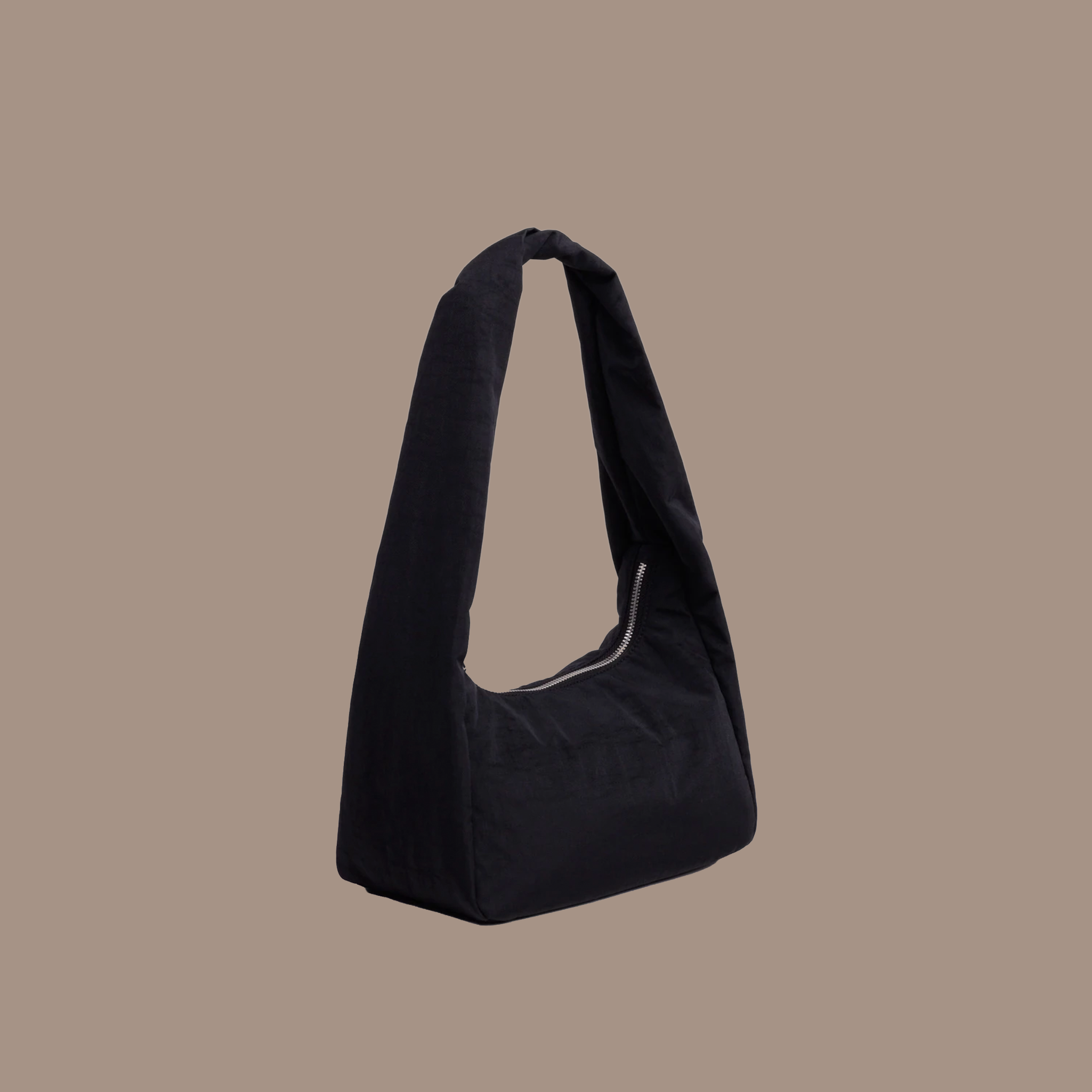 Black nylon purse on a brown background.